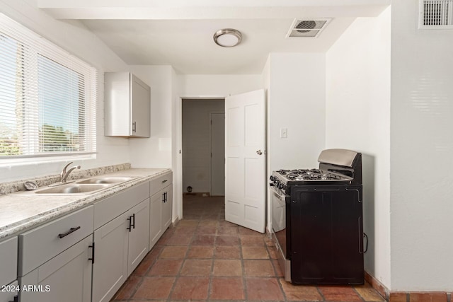 kitchen featuring range with gas stovetop and sink