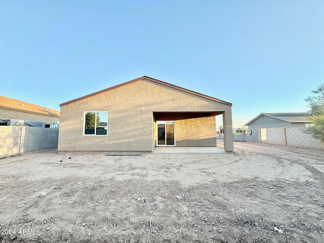 back of property with a patio