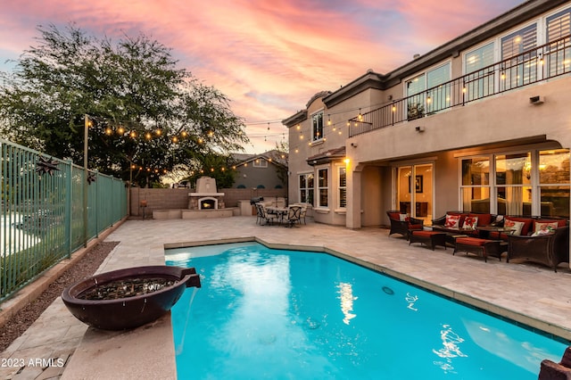 921 E Canyon Way, Chandler, AZ 85249 - pool at dusk with an outdoor living space, a patio, and a fenced backyard