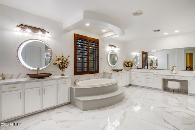 921 E Canyon Way, Chandler, AZ 85249 - bathroom featuring recessed lighting, marble finish flooring, a bath, and two vanities