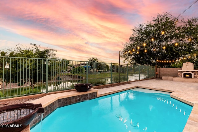921 E Canyon Way, Chandler, AZ 85249 - view of pool featuring a warm lit fireplace, a patio, and a fenced backyard