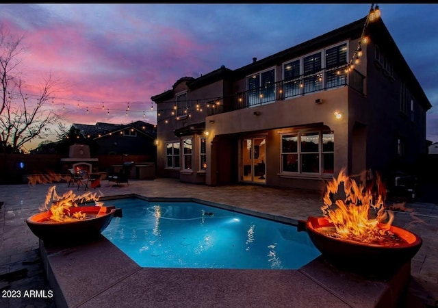 921 E Canyon Way, Chandler, AZ 85249 - pool at dusk featuring a fire pit, a patio, and an outdoor pool