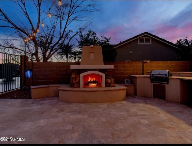 921 E Canyon Way, Chandler, AZ 85249 - view of patio featuring a warm lit fireplace, exterior kitchen, fence, and a grill