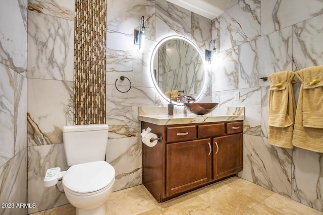 921 E Canyon Way, Chandler, AZ 85249 - bathroom with tile walls, vanity, toilet, and stone wall