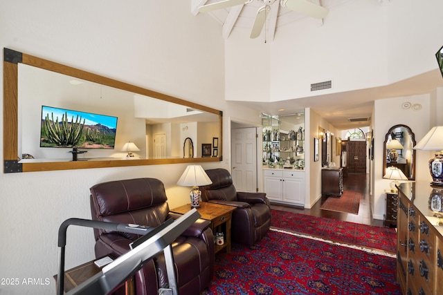 7955 E Chaparral Rd Unit 129, Scottsdale, AZ 85250 - living room with beamed ceiling, ceiling fan, and a towering ceiling