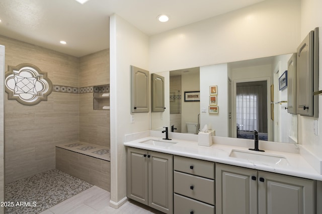 7955 E Chaparral Rd Unit 129, Scottsdale, AZ 85250 - full bathroom with double vanity, a tile shower, and recessed lighting