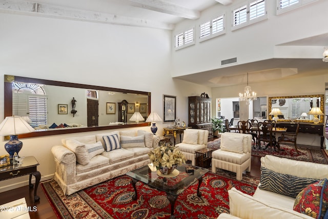7955 E Chaparral Rd Unit 129, Scottsdale, AZ 85250 - living area with a chandelier, a towering ceiling, beamed ceiling, and wood finished floors