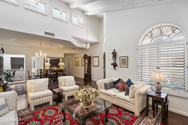 7955 E Chaparral Rd Unit 129, Scottsdale, AZ 85250 - living area featuring a chandelier, wood finished floors, a high ceiling, and beamed ceiling