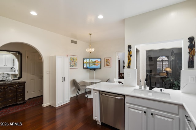 7955 E Chaparral Rd Unit 129, Scottsdale, AZ 85250 - kitchen with dishwasher, dark wood finished floors, white cabinets, light countertops, and arched walkways