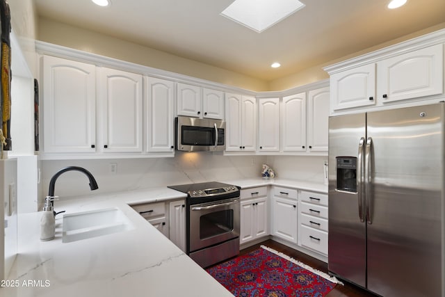 7955 E Chaparral Rd Unit 129, Scottsdale, AZ 85250 - kitchen with stainless steel appliances, recessed lighting, white cabinets, light stone countertops, and dark wood finished floors