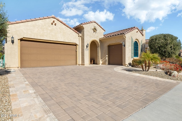 mediterranean / spanish-style house featuring a garage