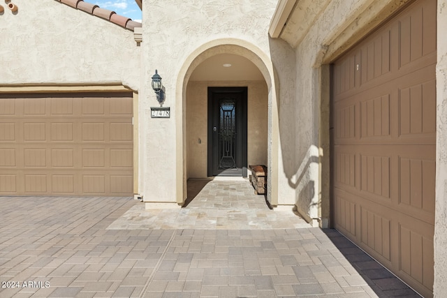 view of exterior entry with a garage