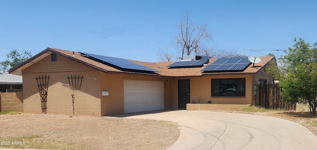 3208 W Port Royale Ln, Phoenix, AZ 85053 - view of front facade featuring concrete driveway, a garage, roof mounted solar panels, and a shingled roof