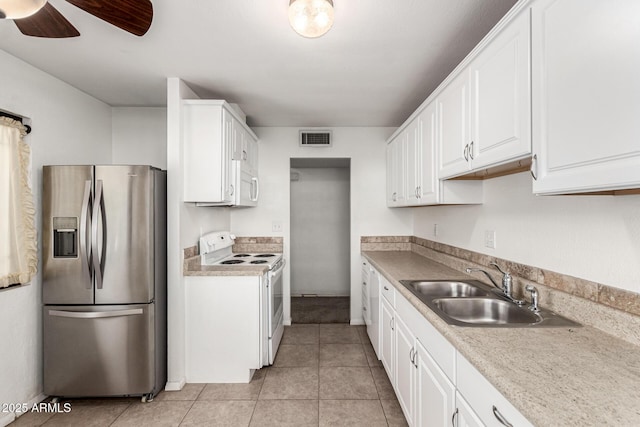 3208 W Port Royale Ln, Phoenix, AZ 85053 - kitchen with white appliances, white cabinets, ceiling fan, and light tile patterned floors