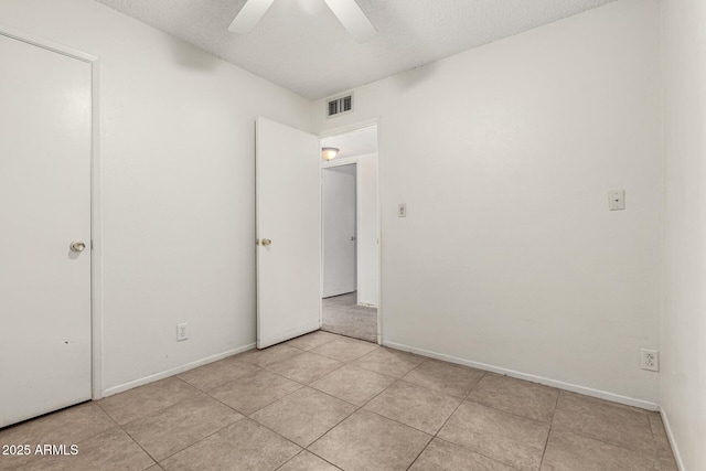 3208 W Port Royale Ln, Phoenix, AZ 85053 - unfurnished bedroom featuring a textured ceiling, ceiling fan, and light tile patterned floors
