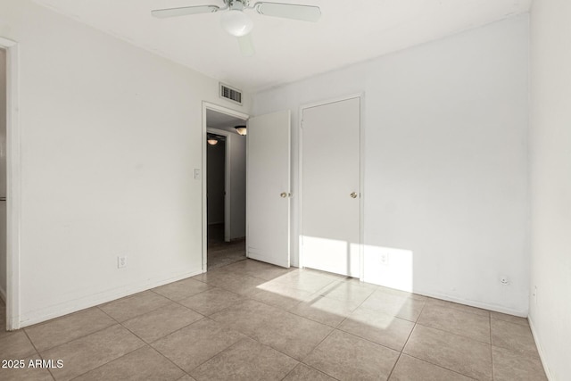 3208 W Port Royale Ln, Phoenix, AZ 85053 - unfurnished bedroom with tile patterned flooring and ceiling fan