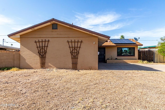 3208 W Port Royale Ln, Phoenix, AZ 85053 - view of front of property with brick siding, solar panels, and a patio