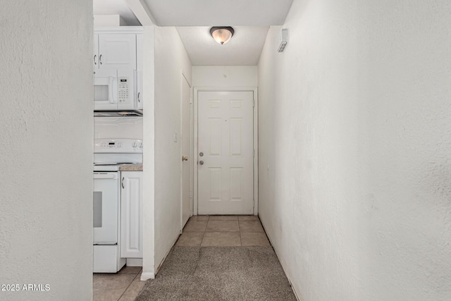 3208 W Port Royale Ln, Phoenix, AZ 85053 - hall with light tile patterned floors, light colored carpet, and a textured wall