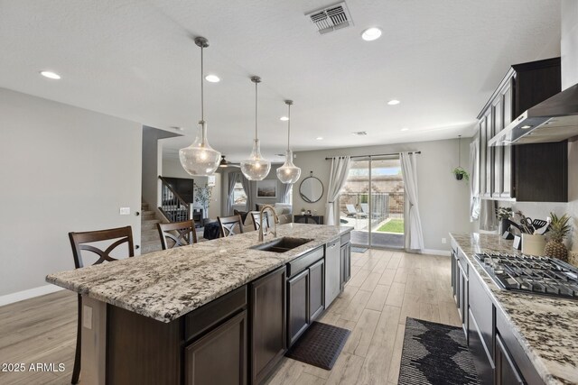 2741 S Gordon, Mesa, AZ 85209 - kitchen featuring a sink, stainless steel gas cooktop, light wood-style flooring, wall chimney range hood, and recessed lighting