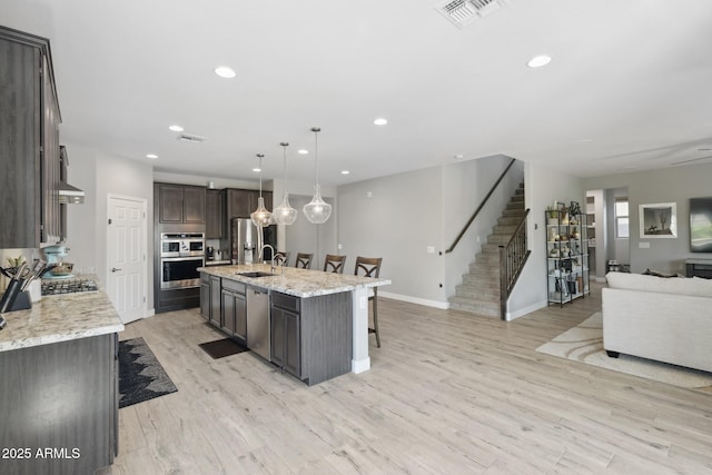2741 S Gordon, Mesa, AZ 85209 - kitchen featuring open floor plan, appliances with stainless steel finishes, a kitchen breakfast bar, a sink, and dark brown cabinetry