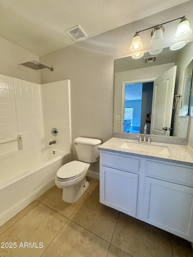 full bathroom featuring tile patterned flooring, vanity, a textured ceiling, bathtub / shower combination, and toilet