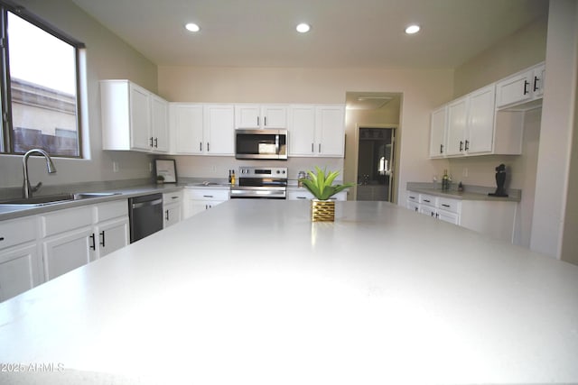 kitchen with white cabinetry, sink, and appliances with stainless steel finishes