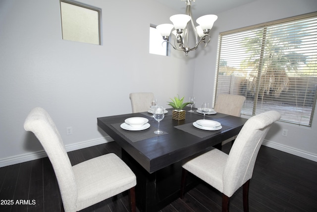 dining space with an inviting chandelier and dark hardwood / wood-style flooring