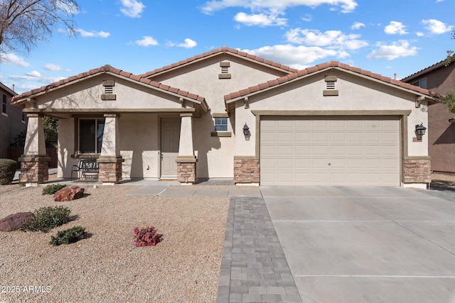 mediterranean / spanish-style home with a garage and covered porch