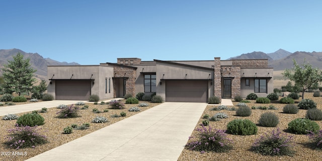 view of front facade with a garage and a mountain view