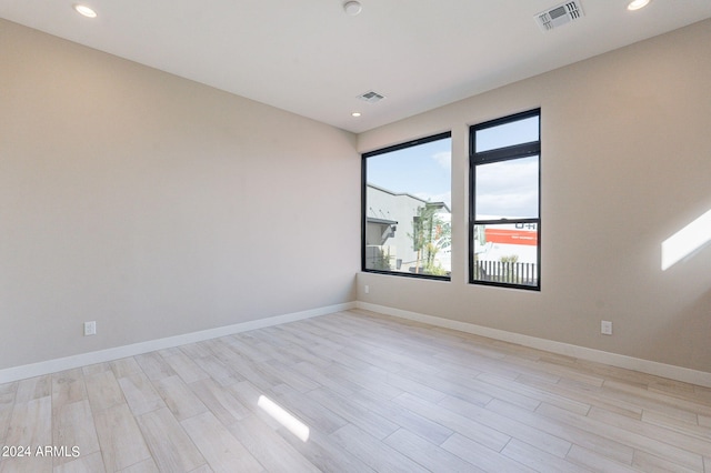 spare room featuring light hardwood / wood-style floors