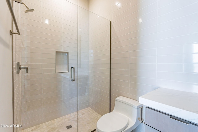 bathroom featuring toilet and an enclosed shower