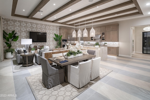 dining space featuring sink and beam ceiling