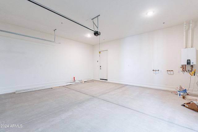 garage featuring tankless water heater and a garage door opener