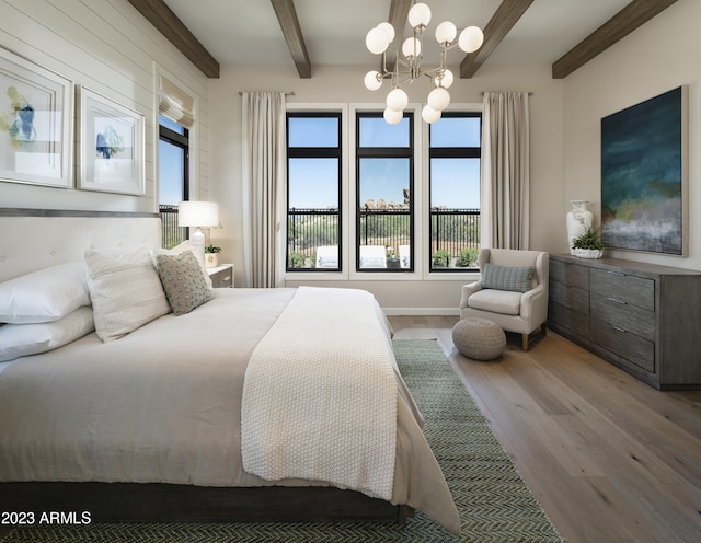 bedroom with beam ceiling, light hardwood / wood-style floors, and a notable chandelier