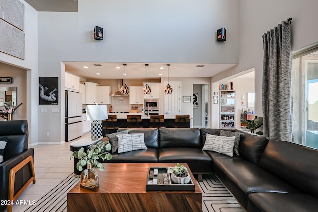 tiled living room with a towering ceiling