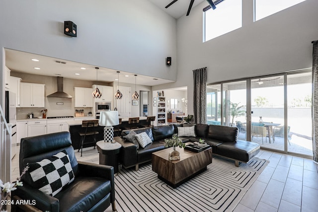 tiled living room featuring a towering ceiling