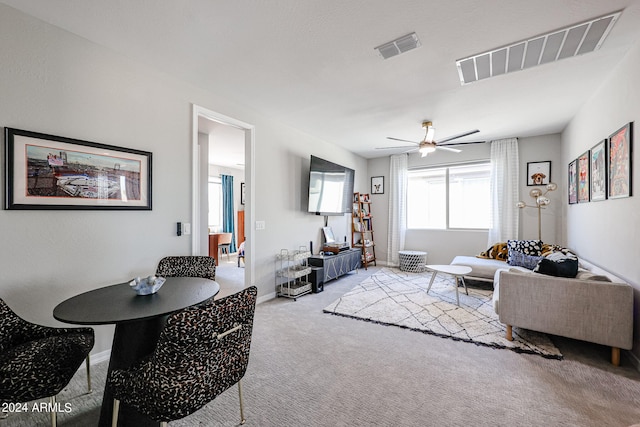 living room featuring light carpet and ceiling fan