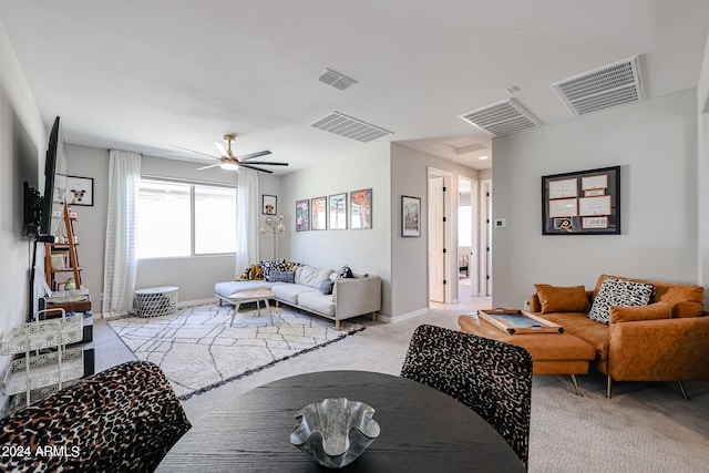 carpeted living room with ceiling fan