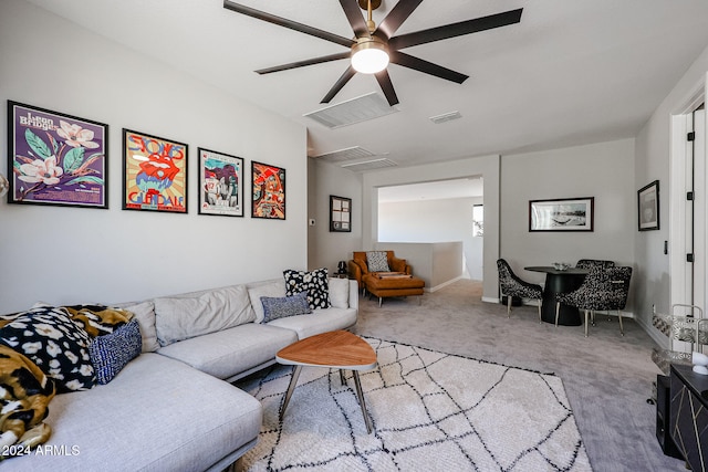 carpeted living room with ceiling fan