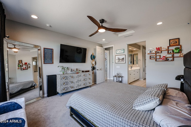 carpeted bedroom featuring ceiling fan and ensuite bath