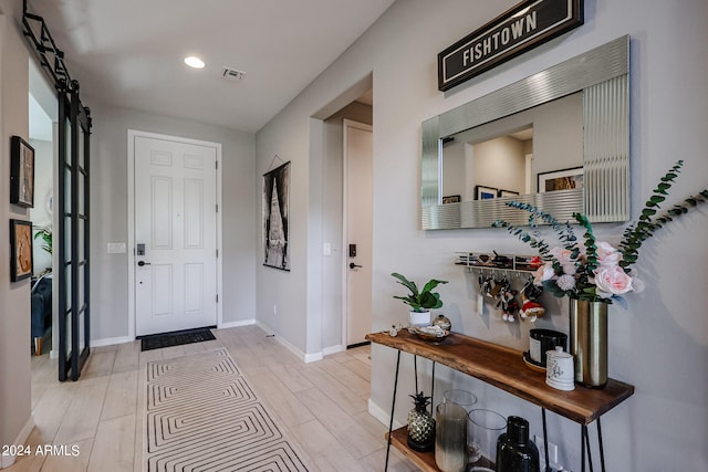 entryway featuring light hardwood / wood-style flooring and a barn door