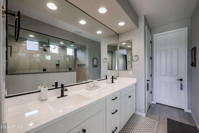 bathroom with vanity and tiled shower