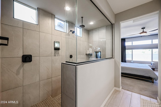 bathroom featuring tile patterned flooring and tiled shower