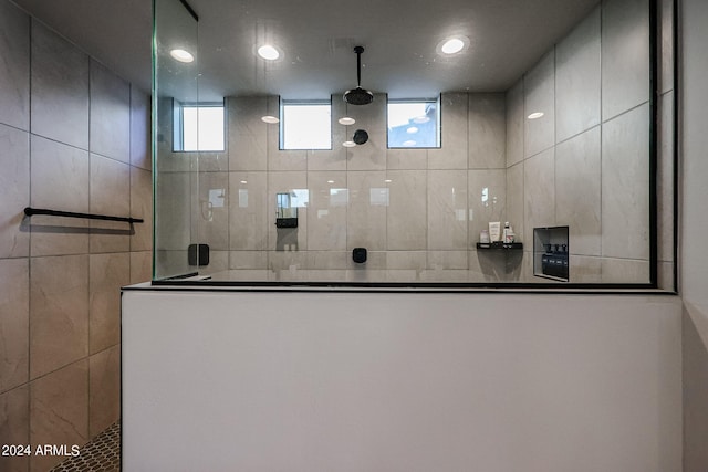 bathroom with a wealth of natural light and tiled shower