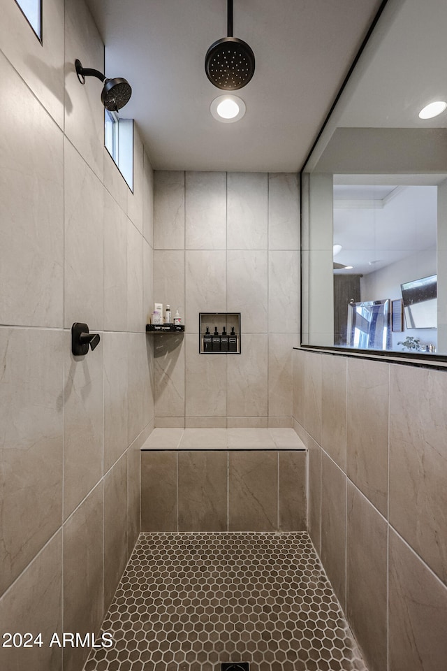 bathroom featuring a tile shower and tile patterned flooring