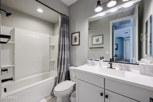 full bathroom with vanity, shower / bath combo, and toilet