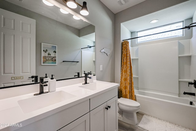 full bathroom with vanity, shower / tub combo with curtain, and toilet