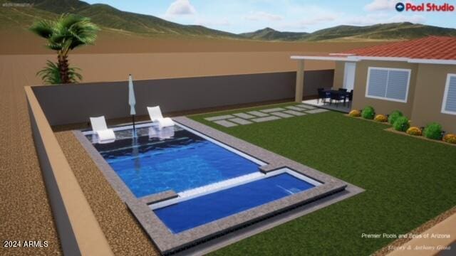 view of pool with a patio, a mountain view, and a lawn