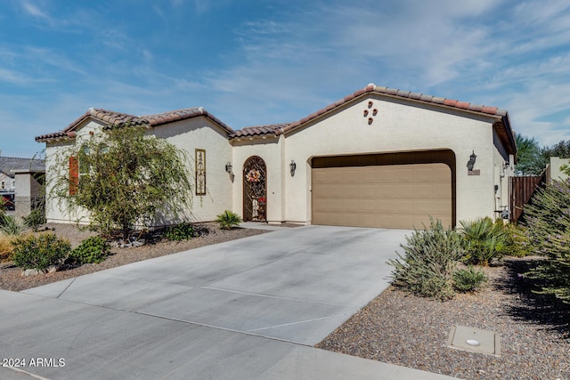 mediterranean / spanish-style house featuring a garage