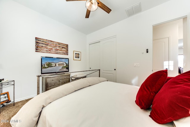 bedroom with a closet, ceiling fan, and carpet flooring